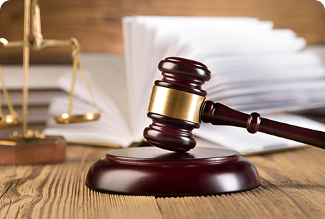 A wooden gavel sitting on top of a table.