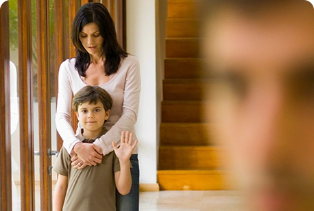 A woman and boy standing in front of stairs.