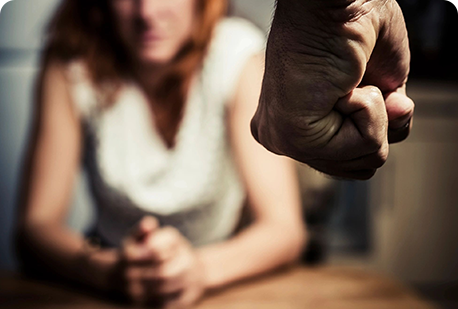 A woman sitting in front of another person.