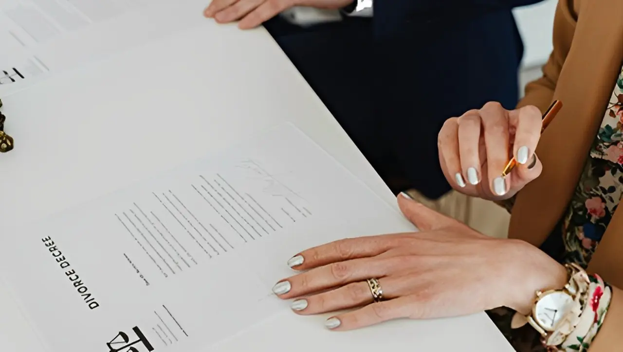 A woman is reading a paper with her hands.